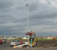 The rubber lining prevents damage, and the second sequencing claw allows for precision setting of light standards and pole buildings