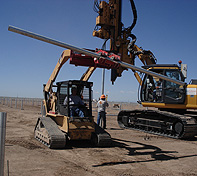 The operator can pick a pole up off the ground or off the back of a trailer